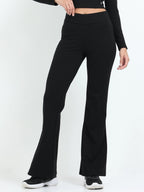 Black flare pants back view showing back pockets and flare hem