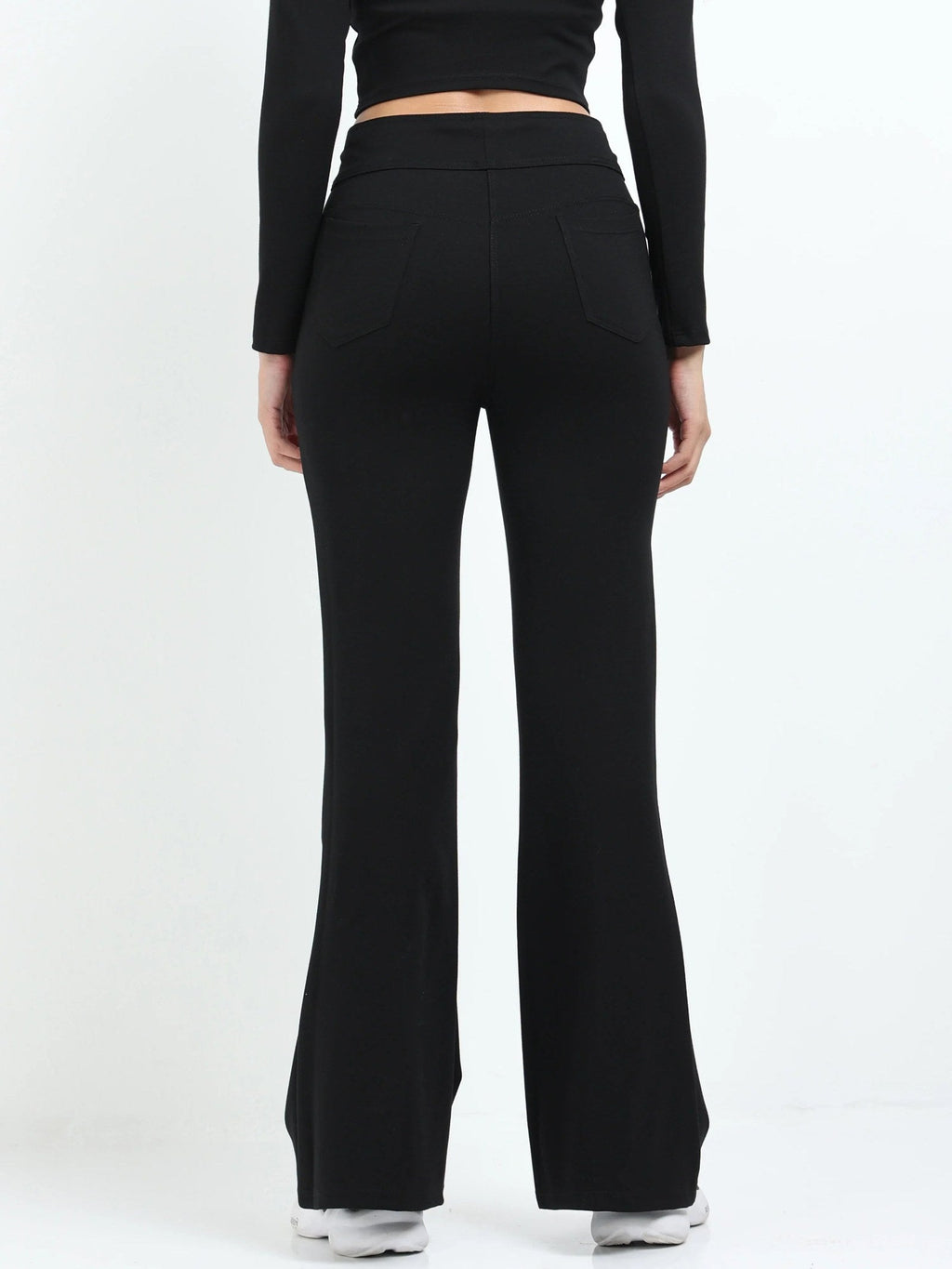 Black flare pants side view showing high-waisted fit and wide flare leg