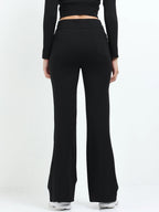 Black flare pants side view showing high-waisted fit and wide flare leg