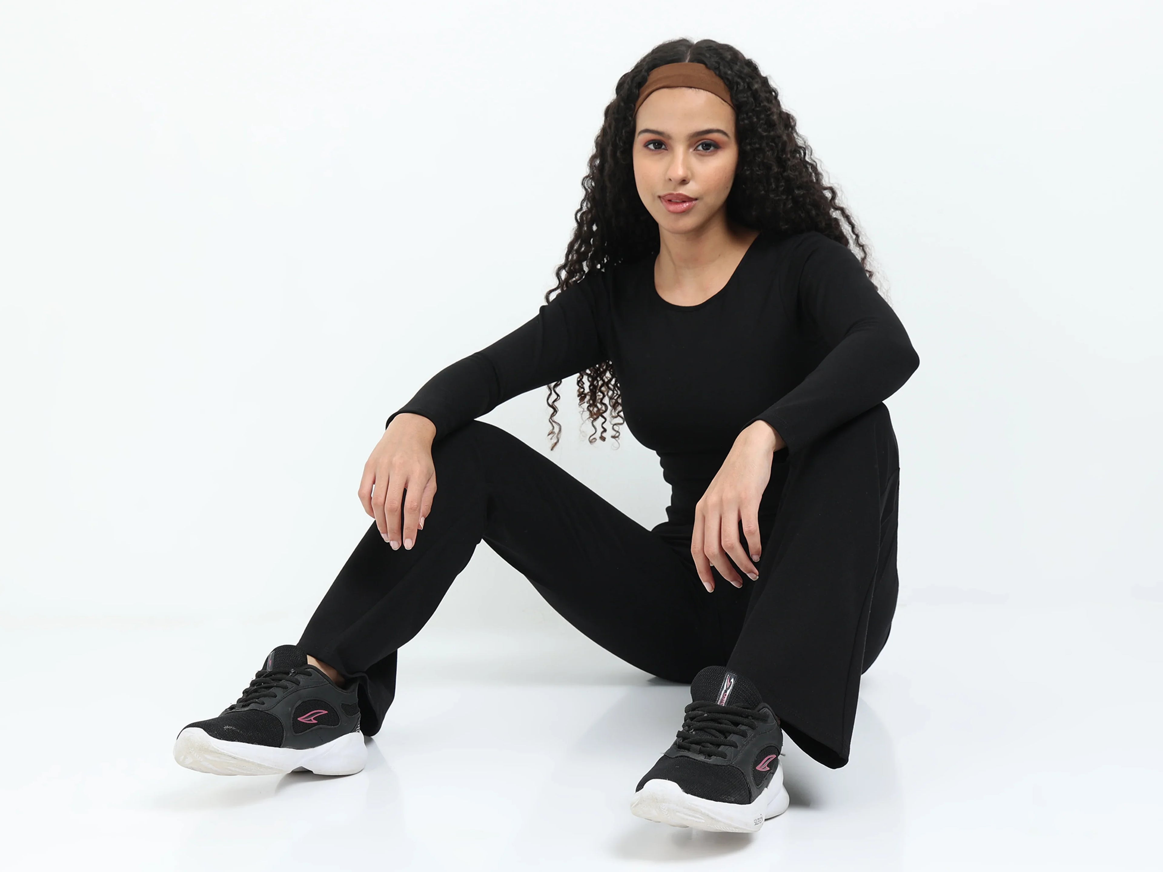 Close-up of black flare pants high-rise waistband detail