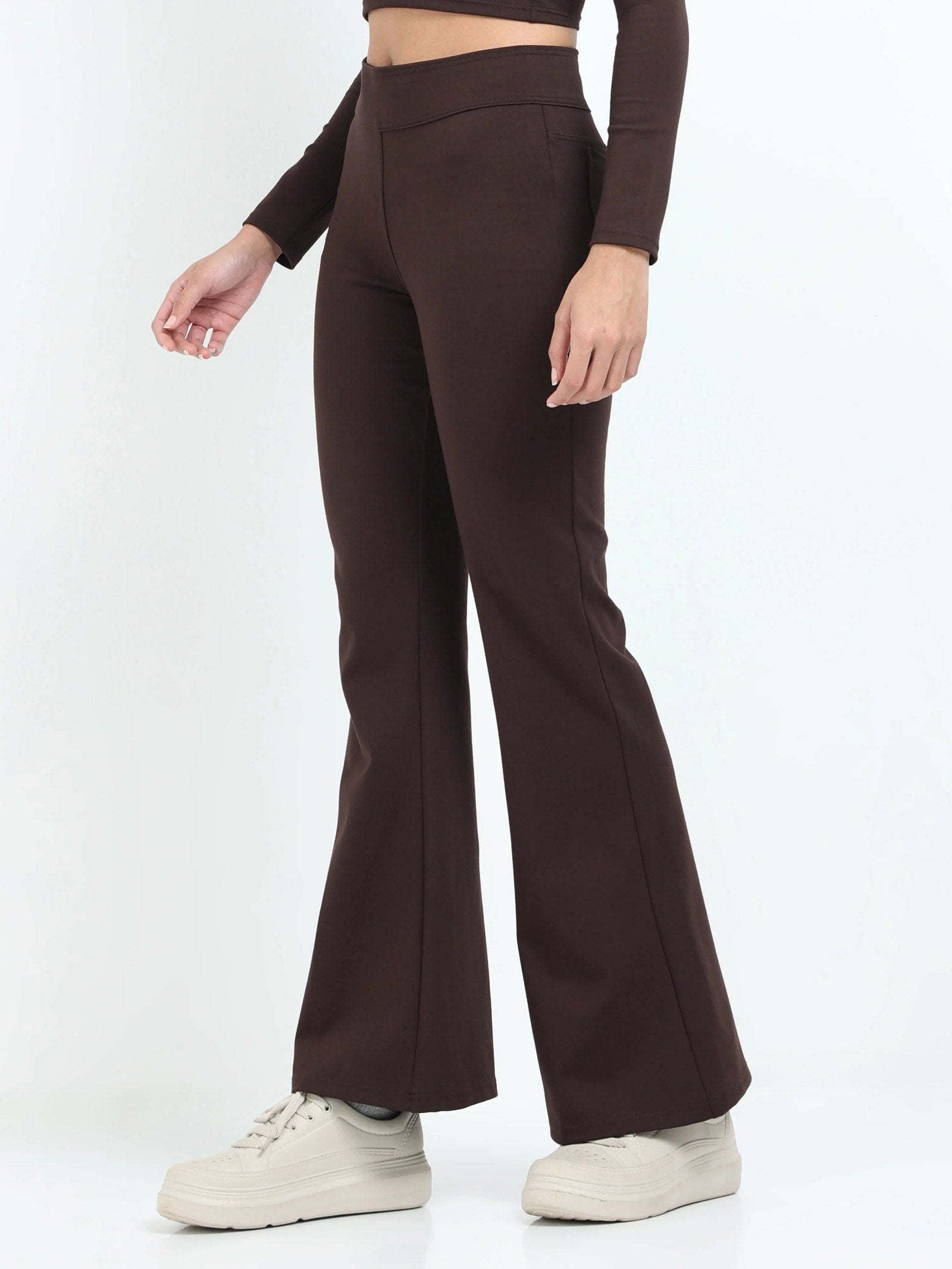 Brown flare pants side view showing high-waisted fit and wide flare leg