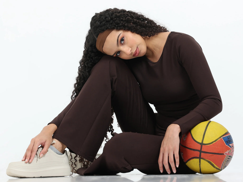 Close-up of brown flare pants high-rise waistband detail