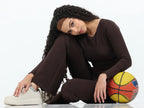 Close-up of brown flare pants high-rise waistband detail