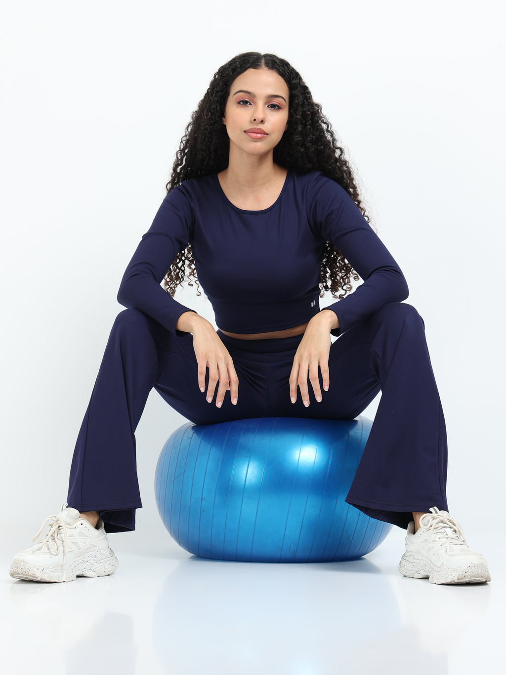 Close-up of navy flare pants high-rise waistband detail