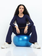 Close-up of navy flare pants high-rise waistband detail