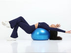 Model in navy long sleeve crop top and leggings performing a kneeling side stretch