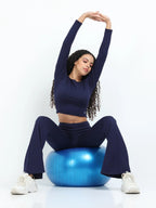 Navy long sleeve crop top lifestyle shot, full body with matching leggings, sneakers and water bottle