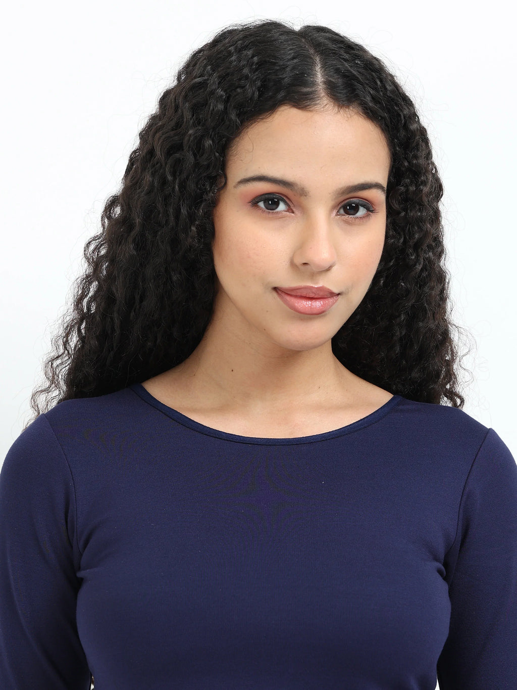Close-up of Yellowcrop logo emblem on navy long sleeve crop top