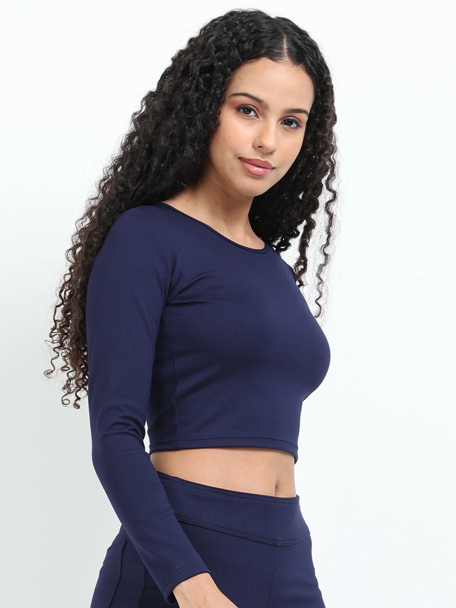 Navy long sleeve crop top side view showing fitted waist-length silhouette