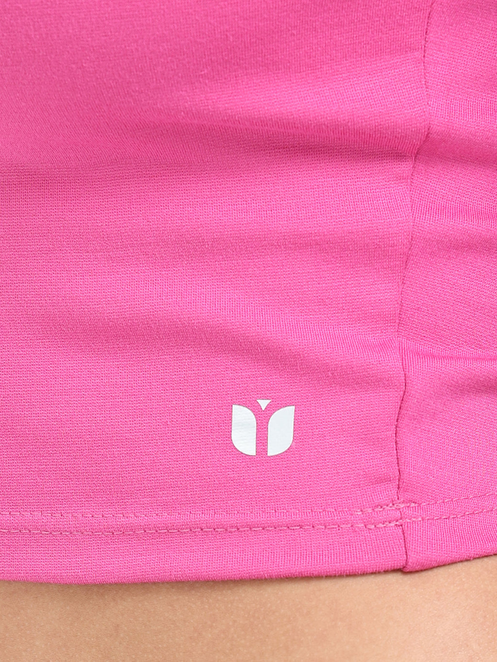 Close-up of fabric texture and stitching on pink long sleeve crop top hem