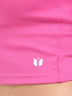 Close-up of fabric texture and stitching on pink long sleeve crop top hem