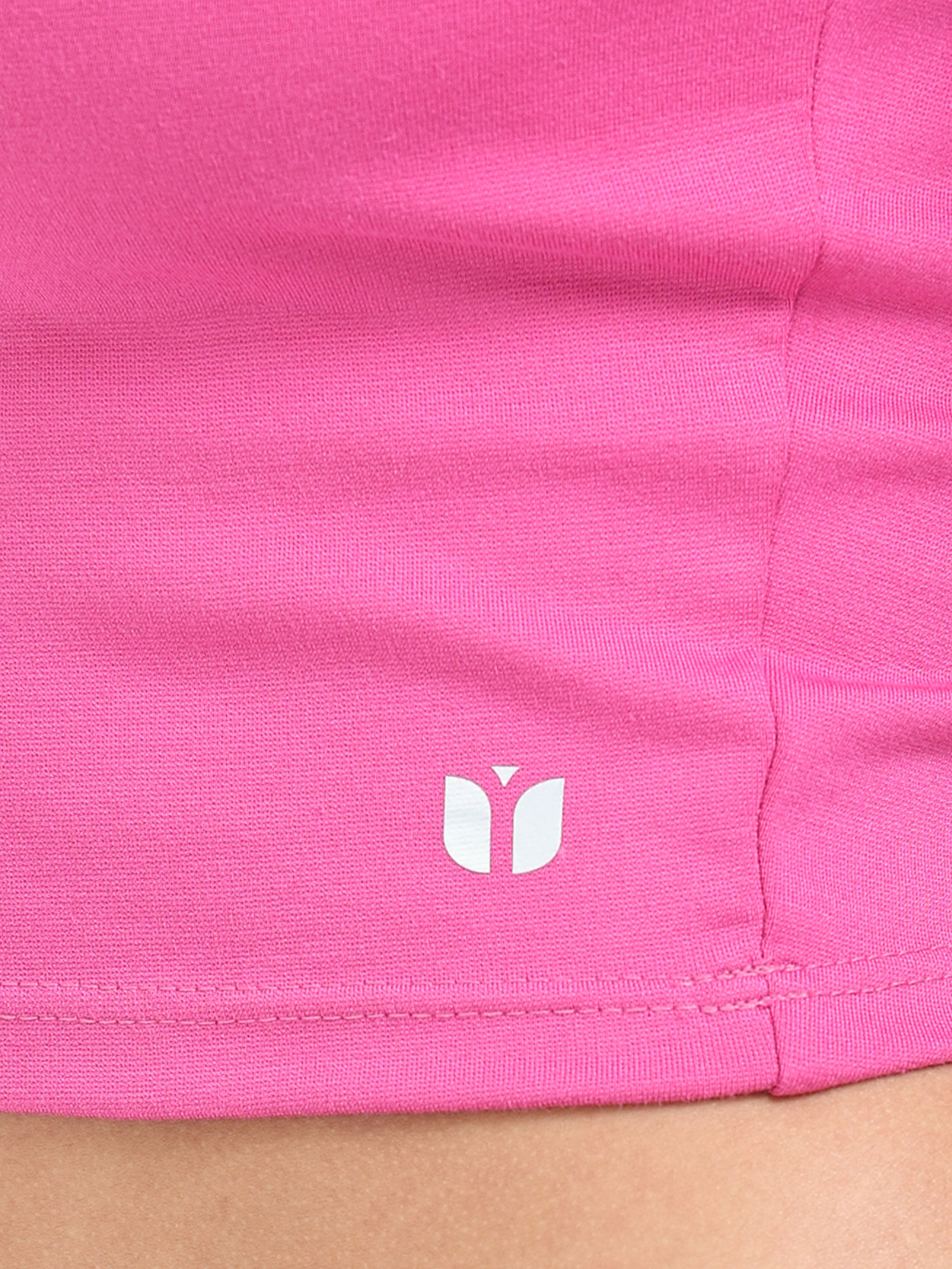 Close-up of fabric texture and stitching on pink long sleeve crop top hem
