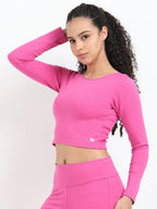Pink long sleeve crop top side view showing fitted waist-length silhouette