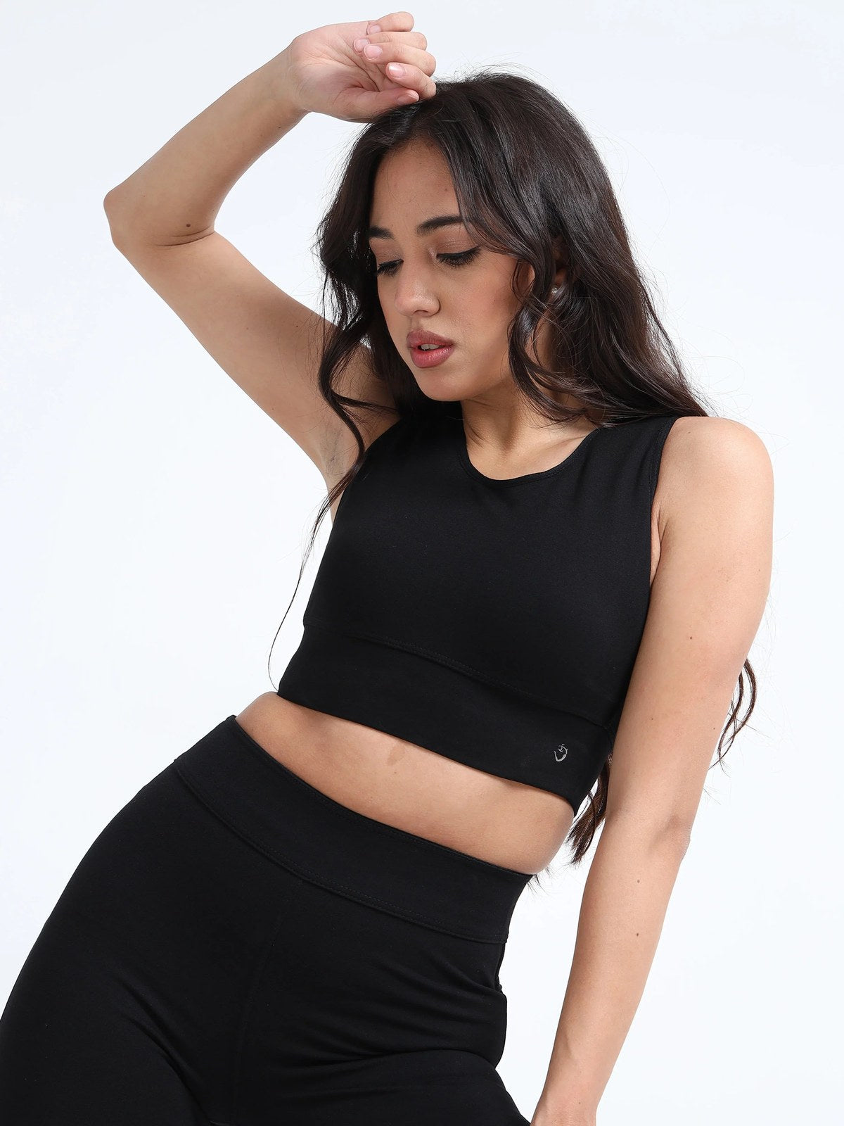 Black sports bra active pose, full body dynamic stance with matching leggings