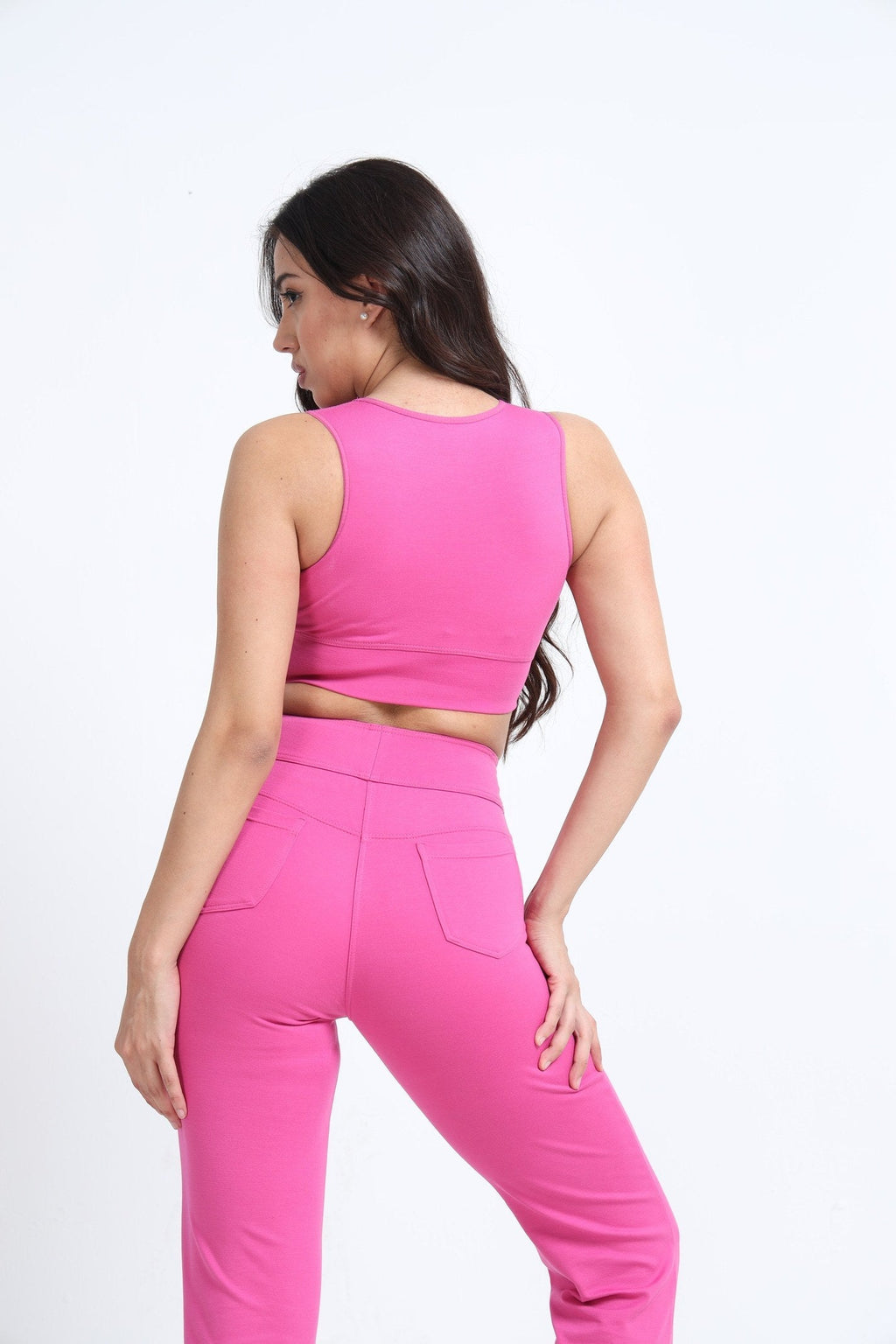 Pink sports bra side view on model