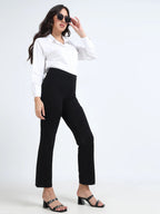 Black straight pants alternate lifestyle pose, model holding sunglasses with block heels