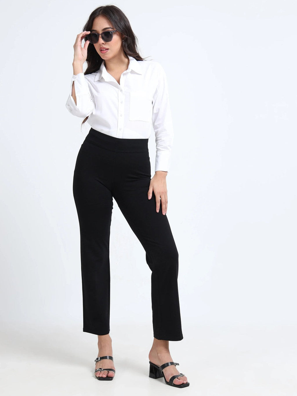 Black straight pants lifestyle shot, full body styled with white shirt and sunglasses