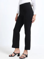 Black straight pants side view showing slim straight leg silhouette