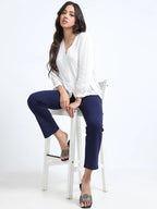 Navy straight pants alternate lifestyle pose, model holding sunglasses with block heels