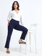 Navy straight pants lifestyle shot, full body styled with white shirt and sunglasses