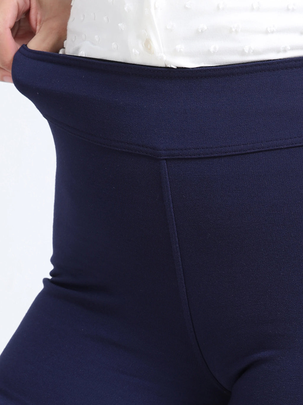 Close-up of navy straight pants high-rise waistband detail